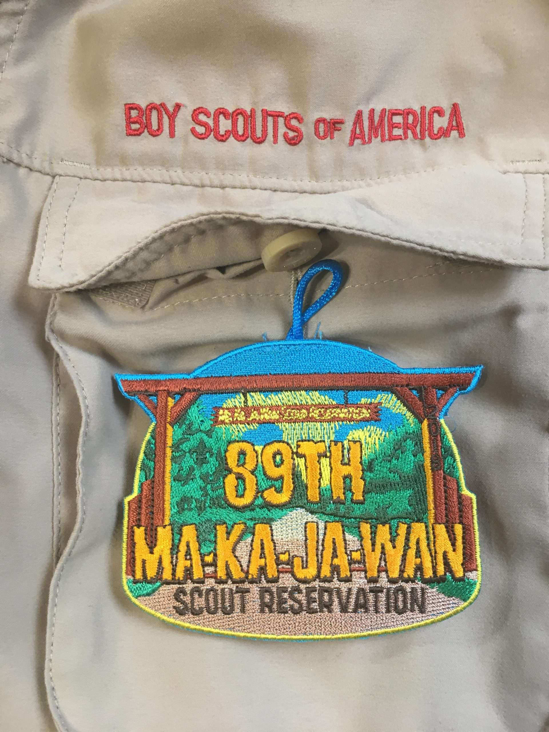 A button-loop award tucked under a pocket flap