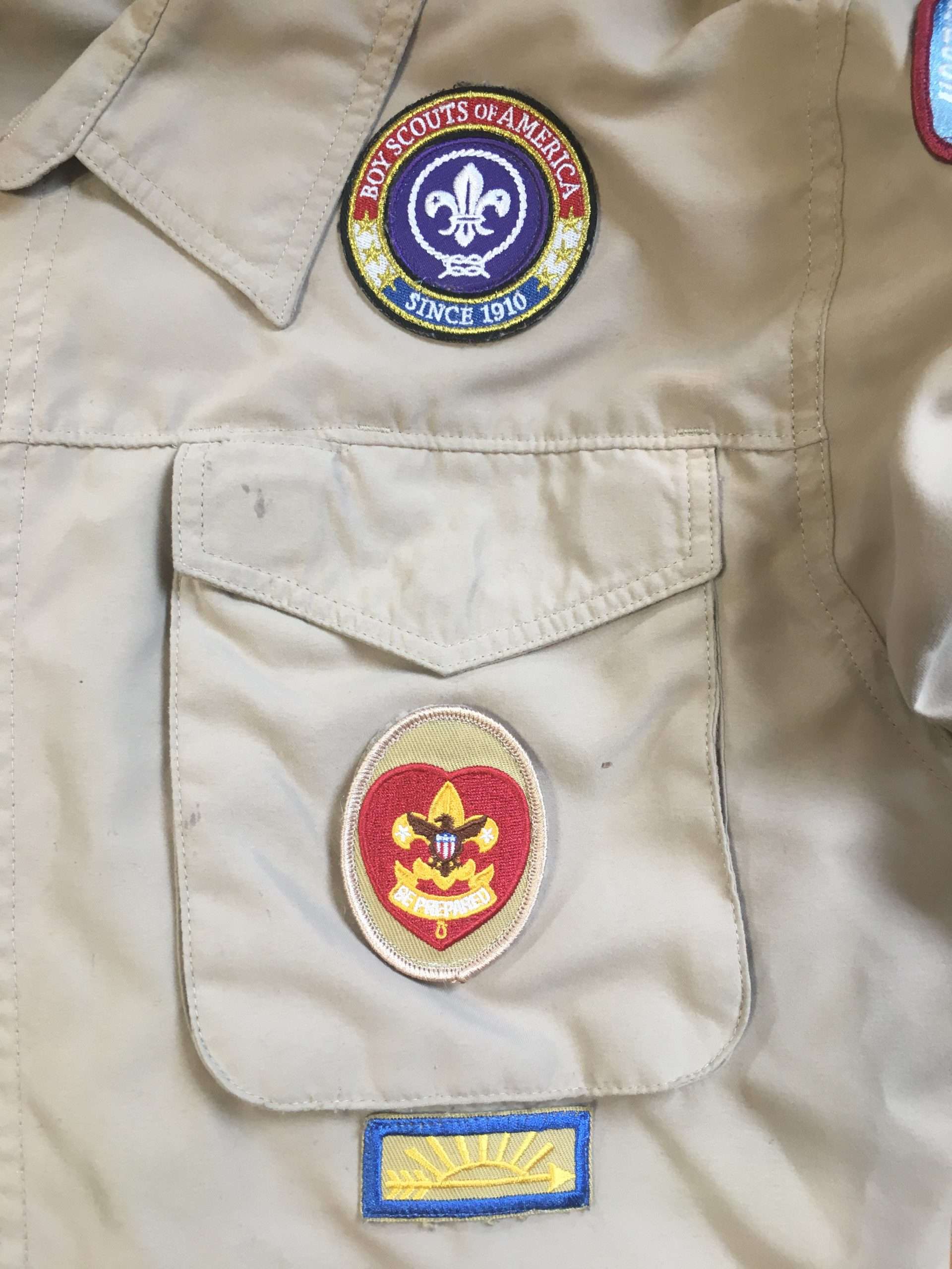 World Crest above the left pocket, rank on the pocket, Arrow of Light below