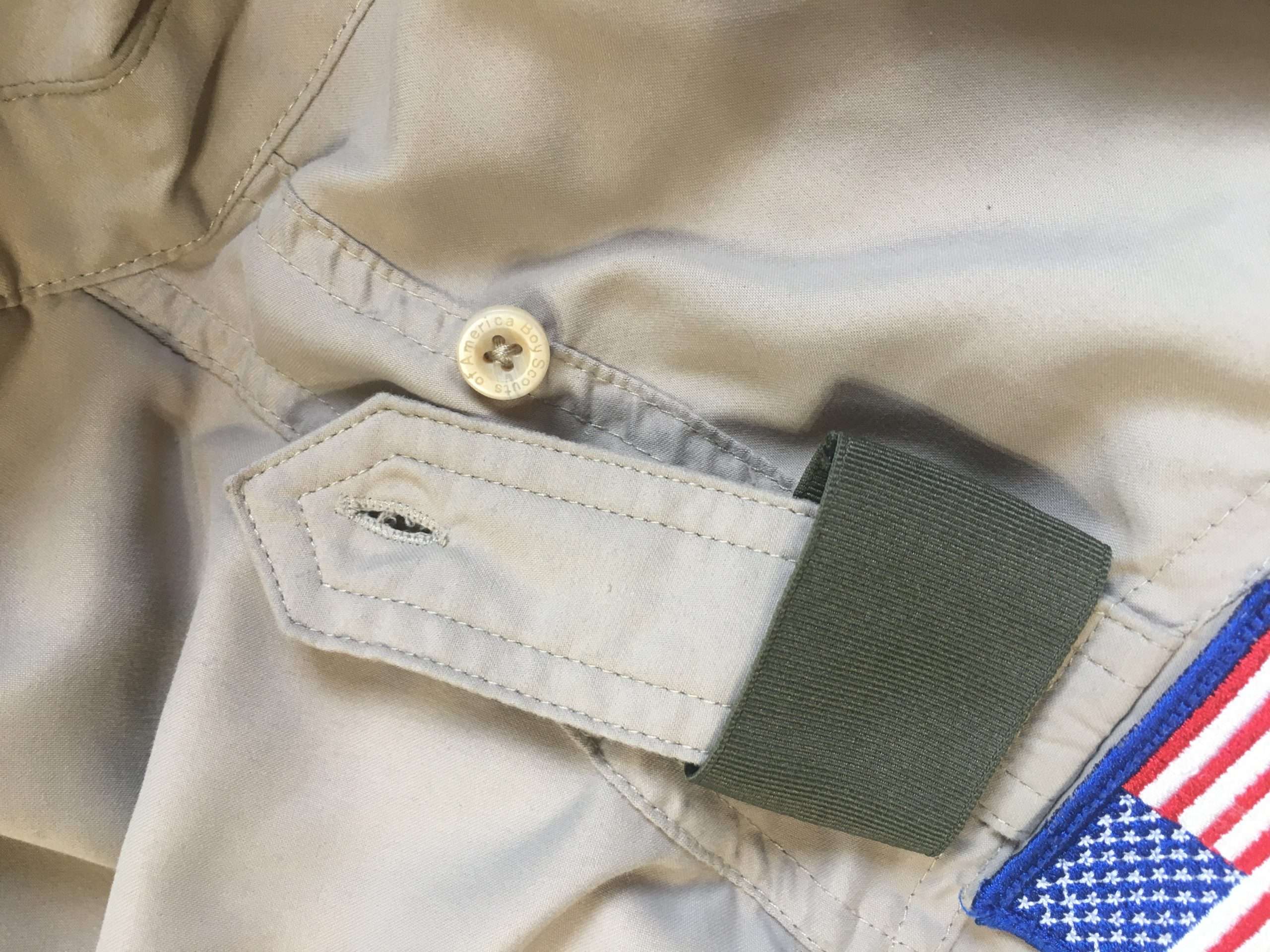 Green shoulder loop buttoned onto an epaulet